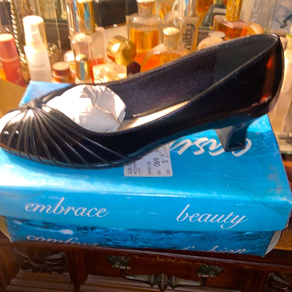 Cagey pump. 2 inch heel. Black Patent leather. 12 wide. Lightly used.